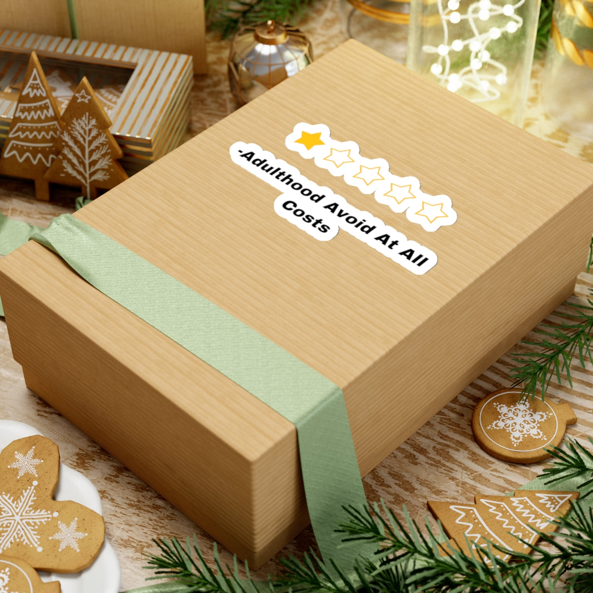 Adulthood review sticker on a wrapped gift box with festive holiday decorations and gingerbread cookies