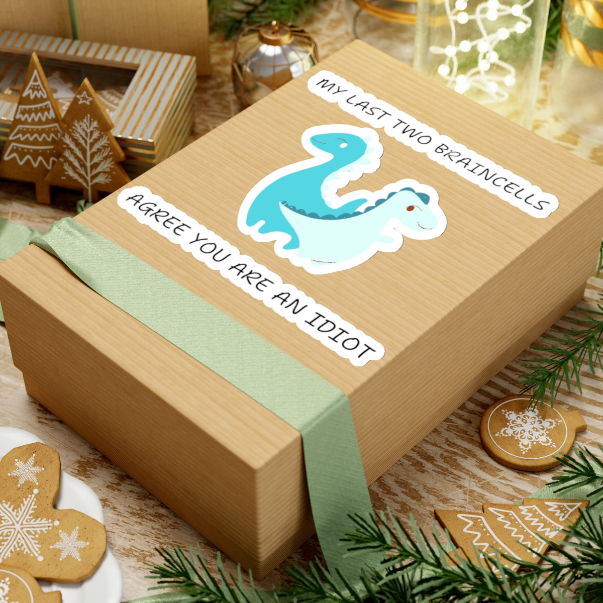 Cute dinosaur meme stickers with funny text on a brown gift box surrounded by holiday decorations