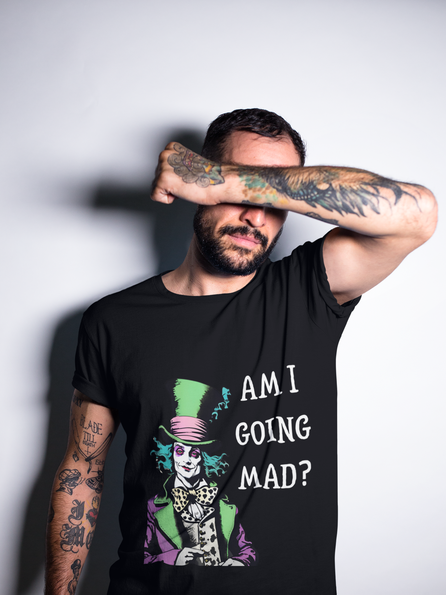 Printify mad hatter am i going mad vintage unisex shirt worn by tattooed man covering face with arm