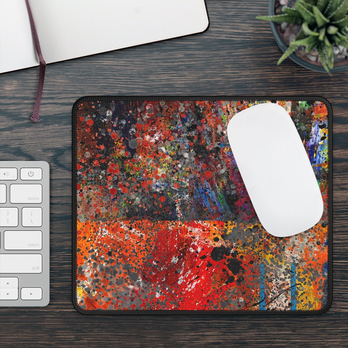 Printify red and orange abstract splatter art mousepad on wood desk with white wireless mouse keyboard and succulent plant