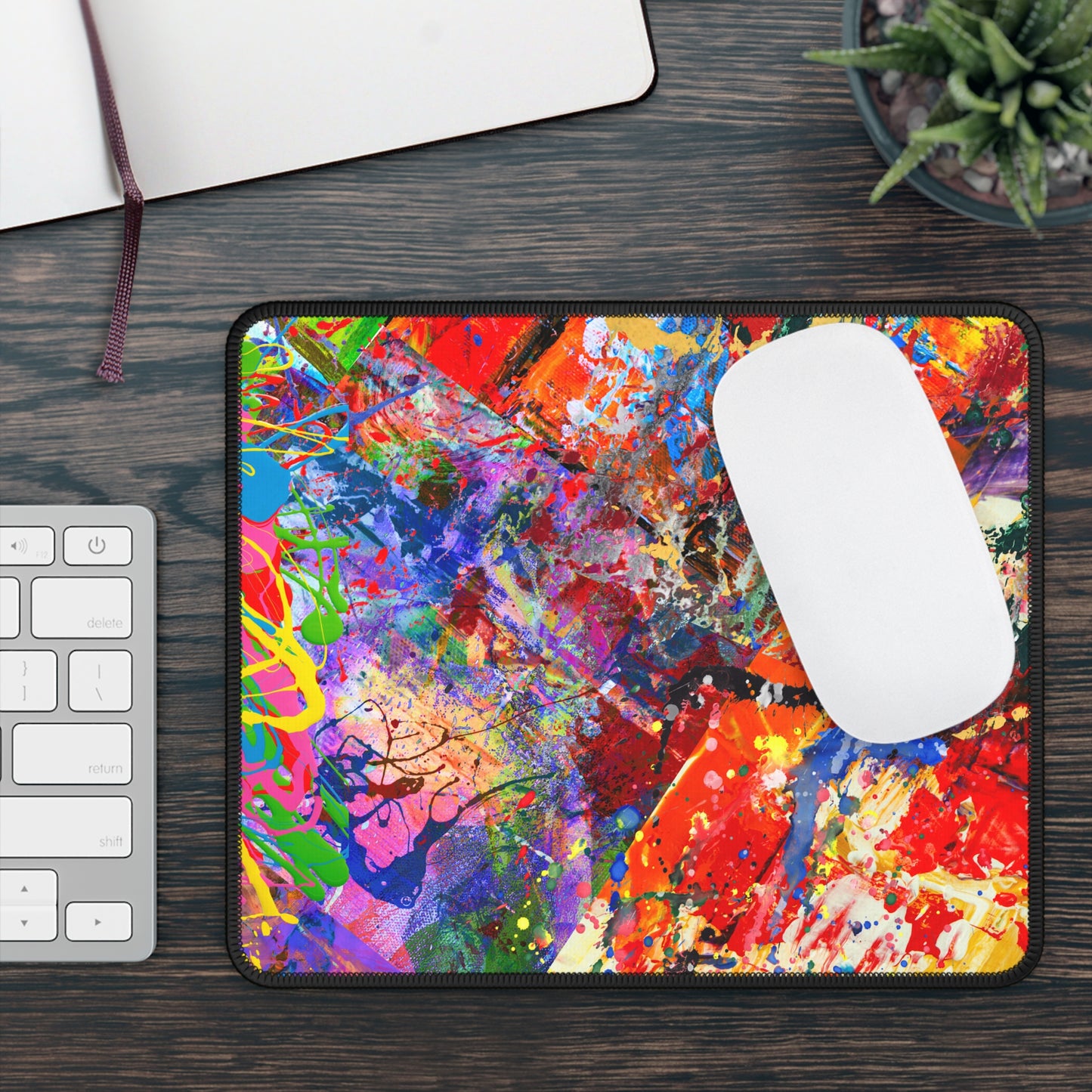Printify kaleidoscope collision bold colorful abstract art mousepad with vibrant paint splatter on dark wood desk and white mouse