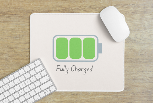 Printify fully charged gaming mouse pad on wood desk with white wireless mouse keyboard and green battery icon