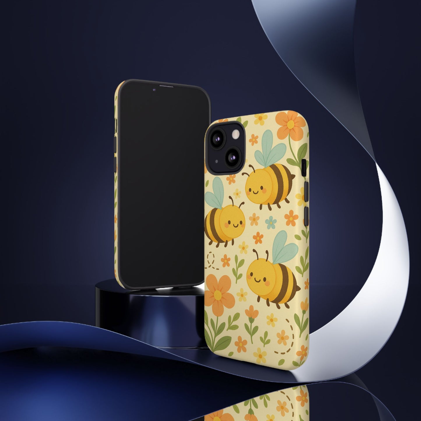The Printify Cute cartoon Floral Bee Tough Phone Case, decorated with bees, flowers, and green leaves, stands upright in front of a blank-screen phone against a dark, abstract background with ribbon-like shapes.
