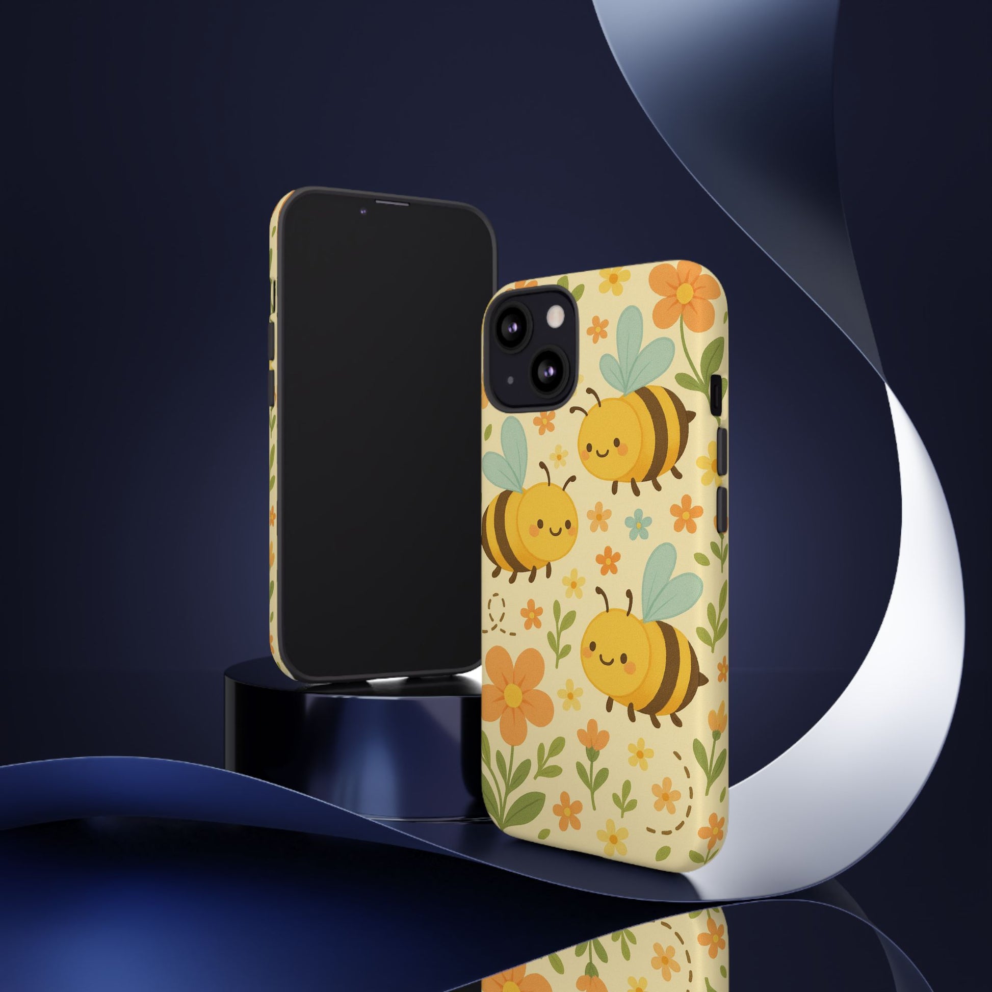 The Printify Cute cartoon Floral Bee Tough Phone Case, decorated with bees, flowers, and green leaves, stands upright in front of a blank-screen phone against a dark, abstract background with ribbon-like shapes.