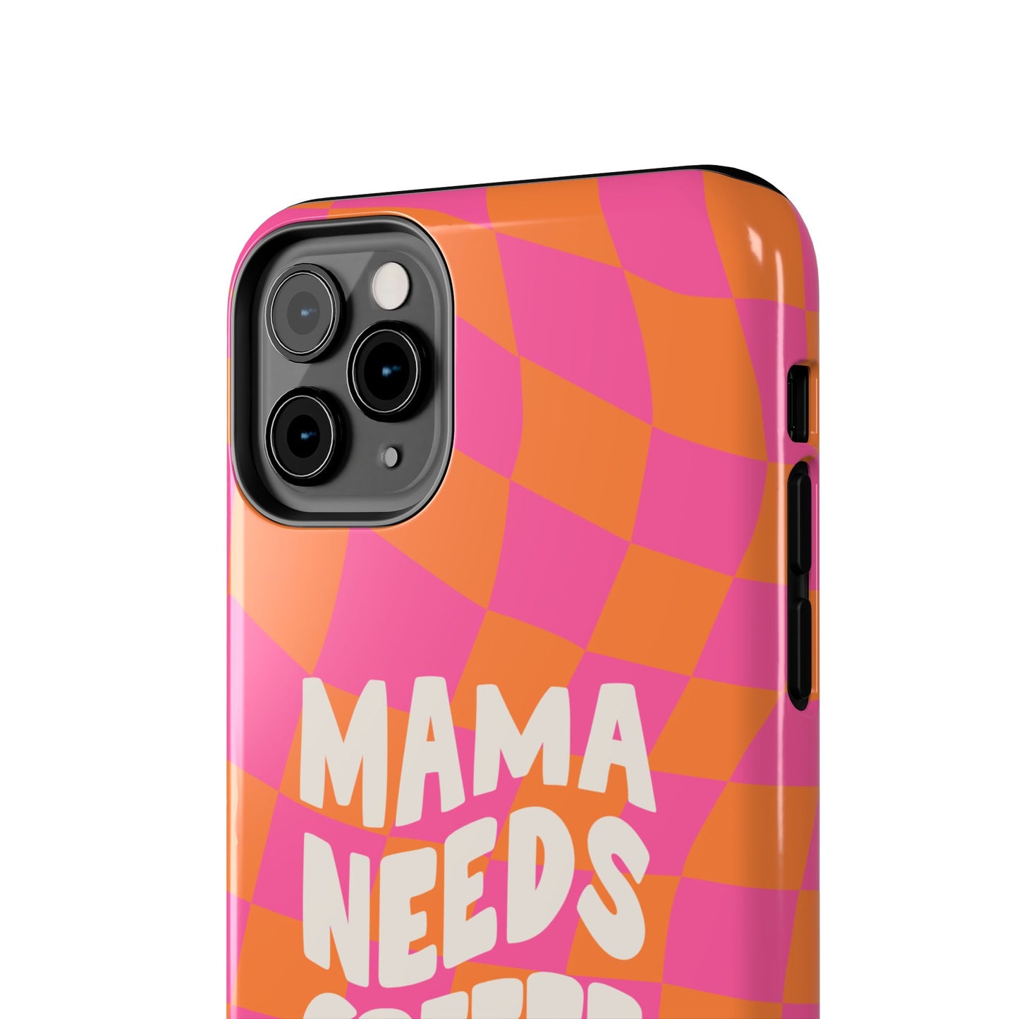 A close-up of the Mama Needs Coffee Funny Tough Phone Case for smartphones, with an orange and pink checkered design and "MAMA NEEDS" in bold white letters. The camera and side buttons are visible—perfect for coffee lovers!.