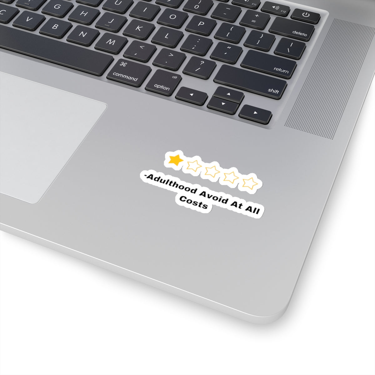 Adulthood review sticker with one star rating on silver laptop near keyboard from Printify