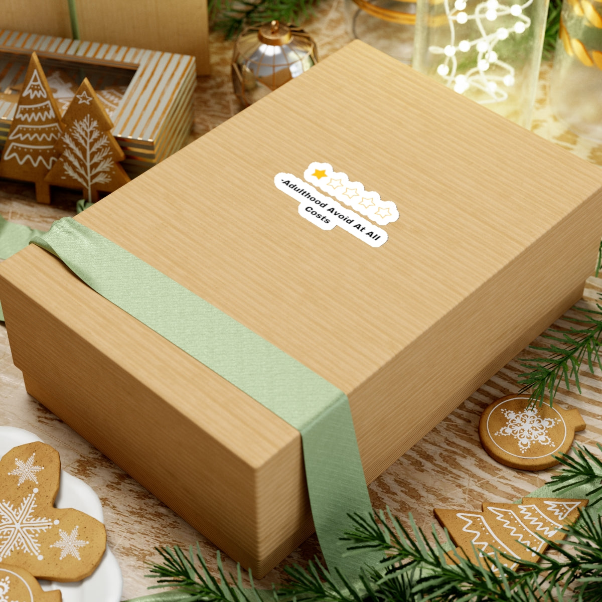 Adulthood review sticker on a brown gift box with green ribbon surrounded by holiday decorations