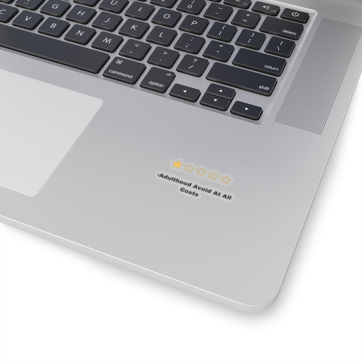 Adulthood review sticker with one star rating on silver laptop near keyboard by Printify