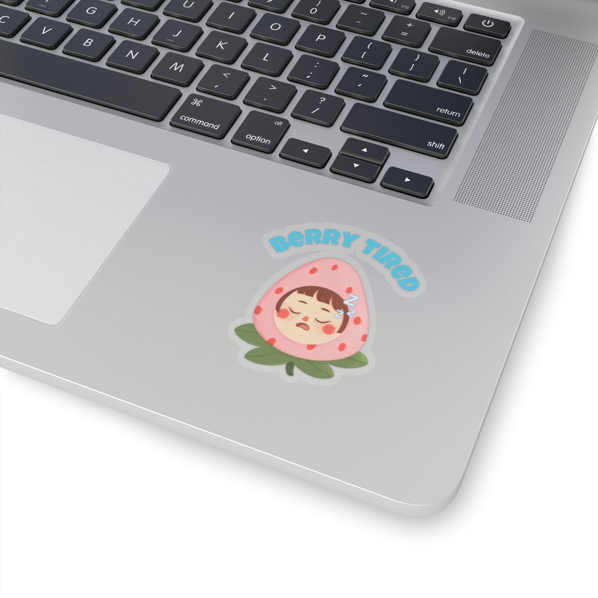 Berry tired vinyl sticker featuring a sleeping character inside a strawberry on a silver laptop