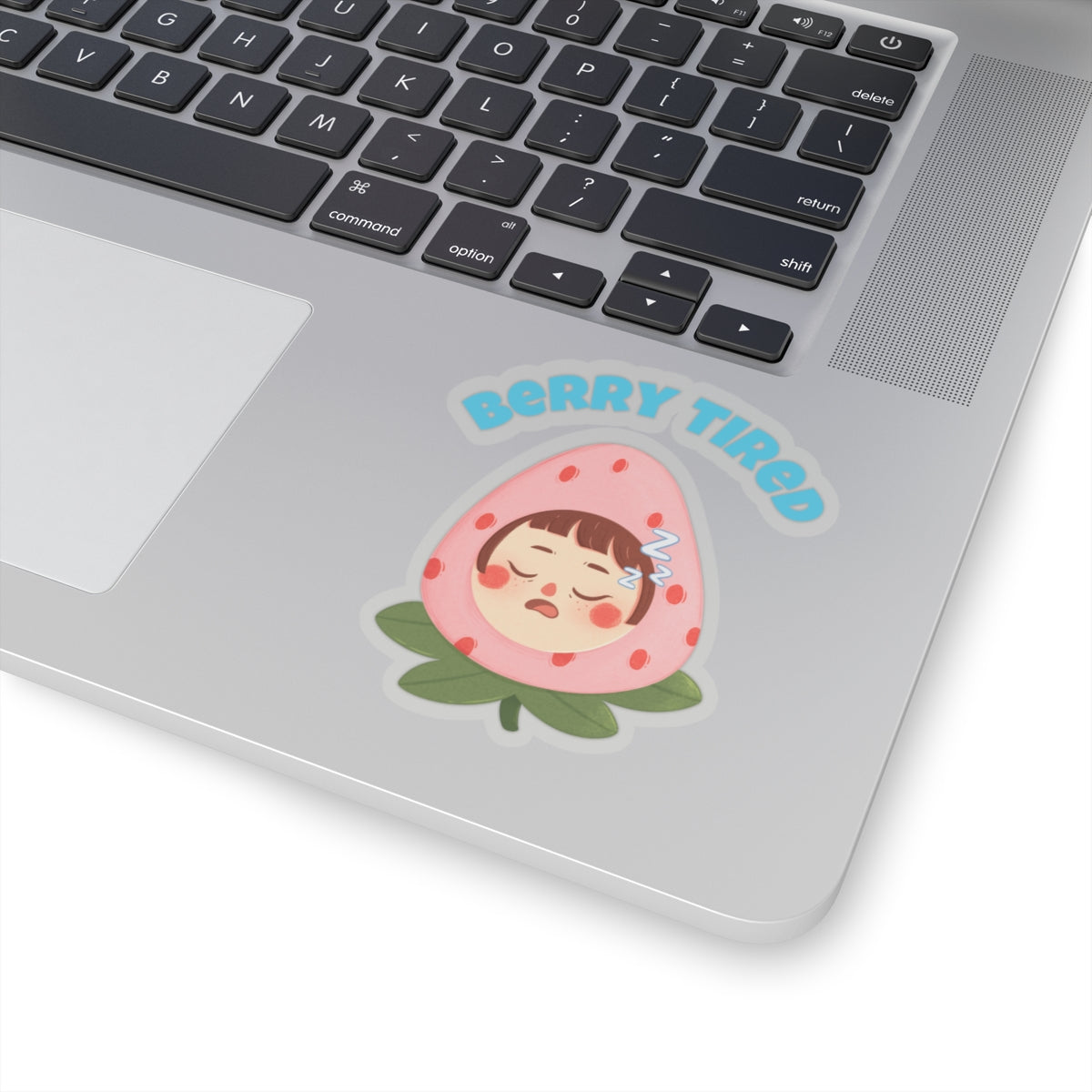 Berry tired vinyl sticker of a sleepy face inside a pink strawberry on a laptop