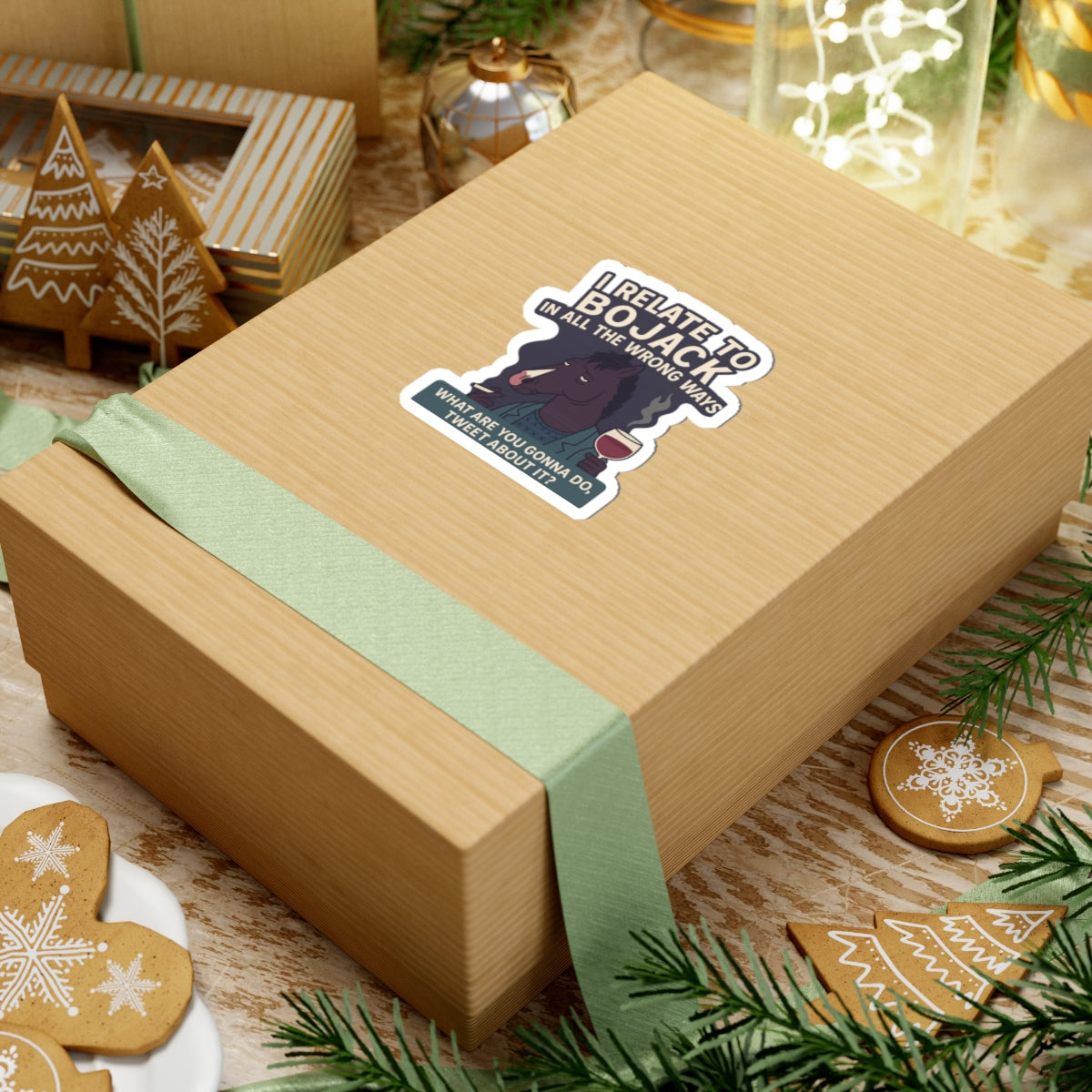 BoJack Horseman sticker on a gift box with green ribbon and holiday decorations around it