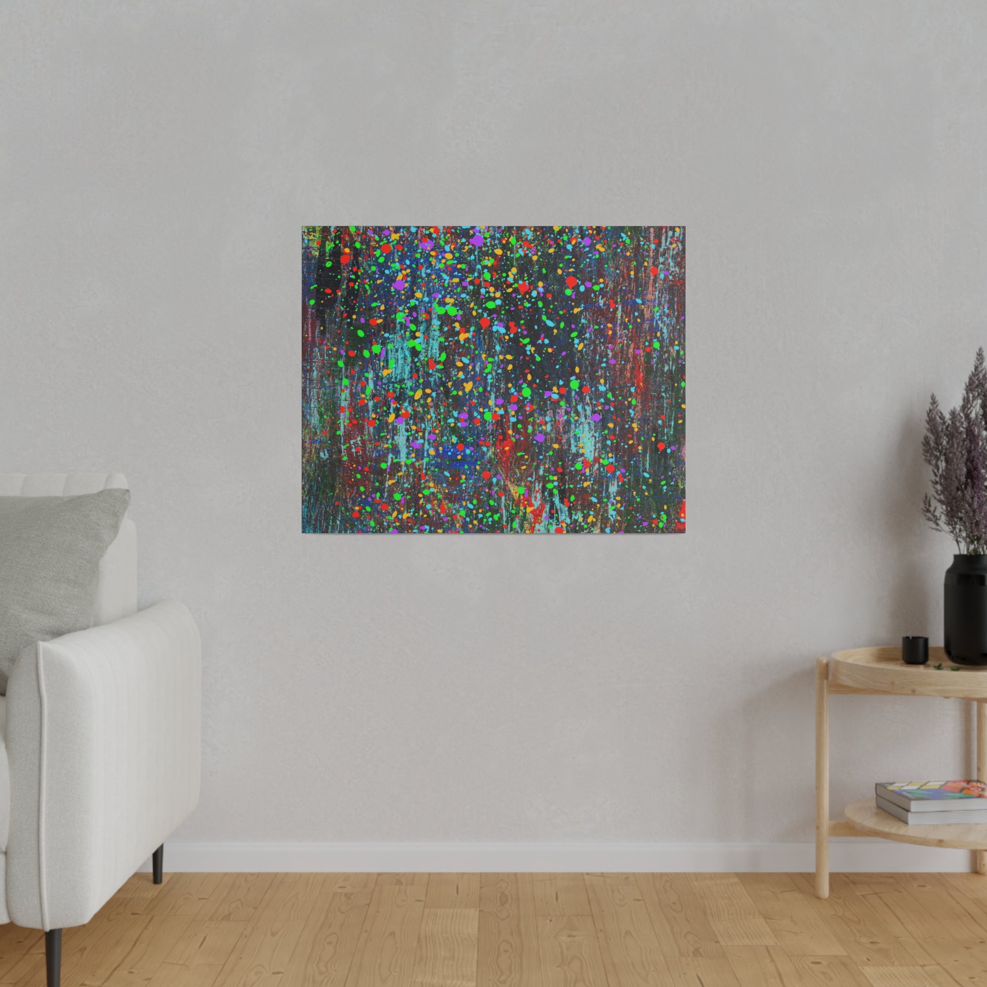 Color drip explosion art canvas print by Printify hanging on a gray wall above wooden floor