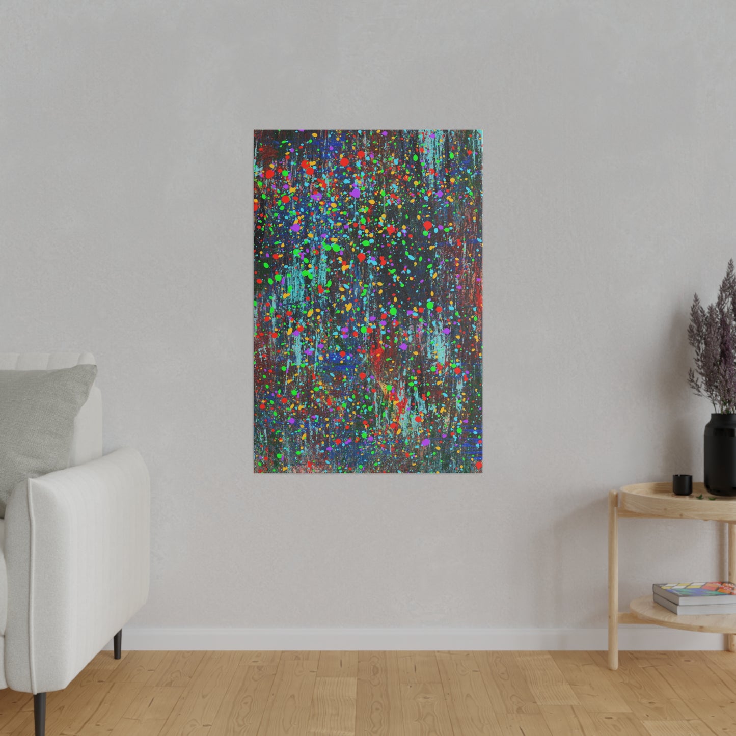 Color drip explosion art canvas print on wall in modern living room with white sofa and wooden side table