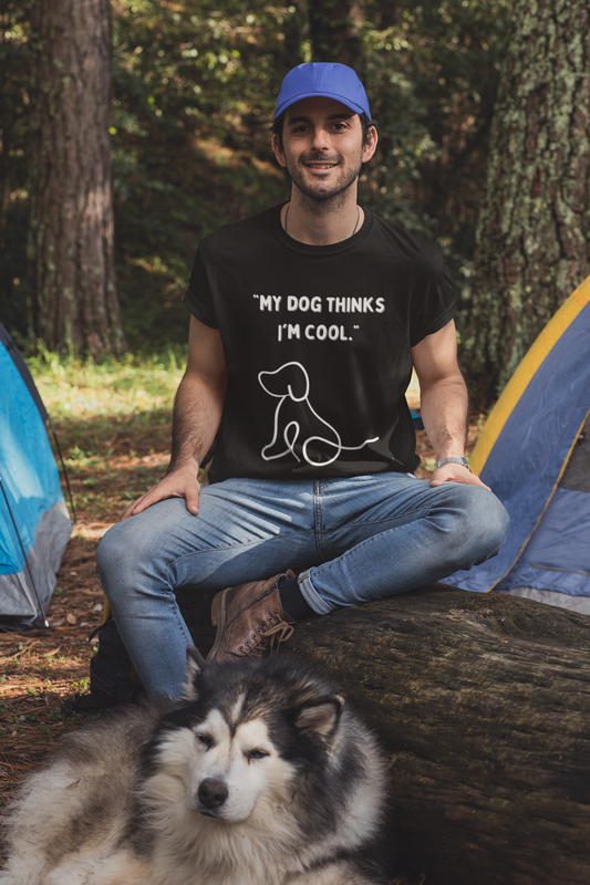 Man wearing a black dog thinks I am cool dog unisex shirt while sitting outdoors with a dog