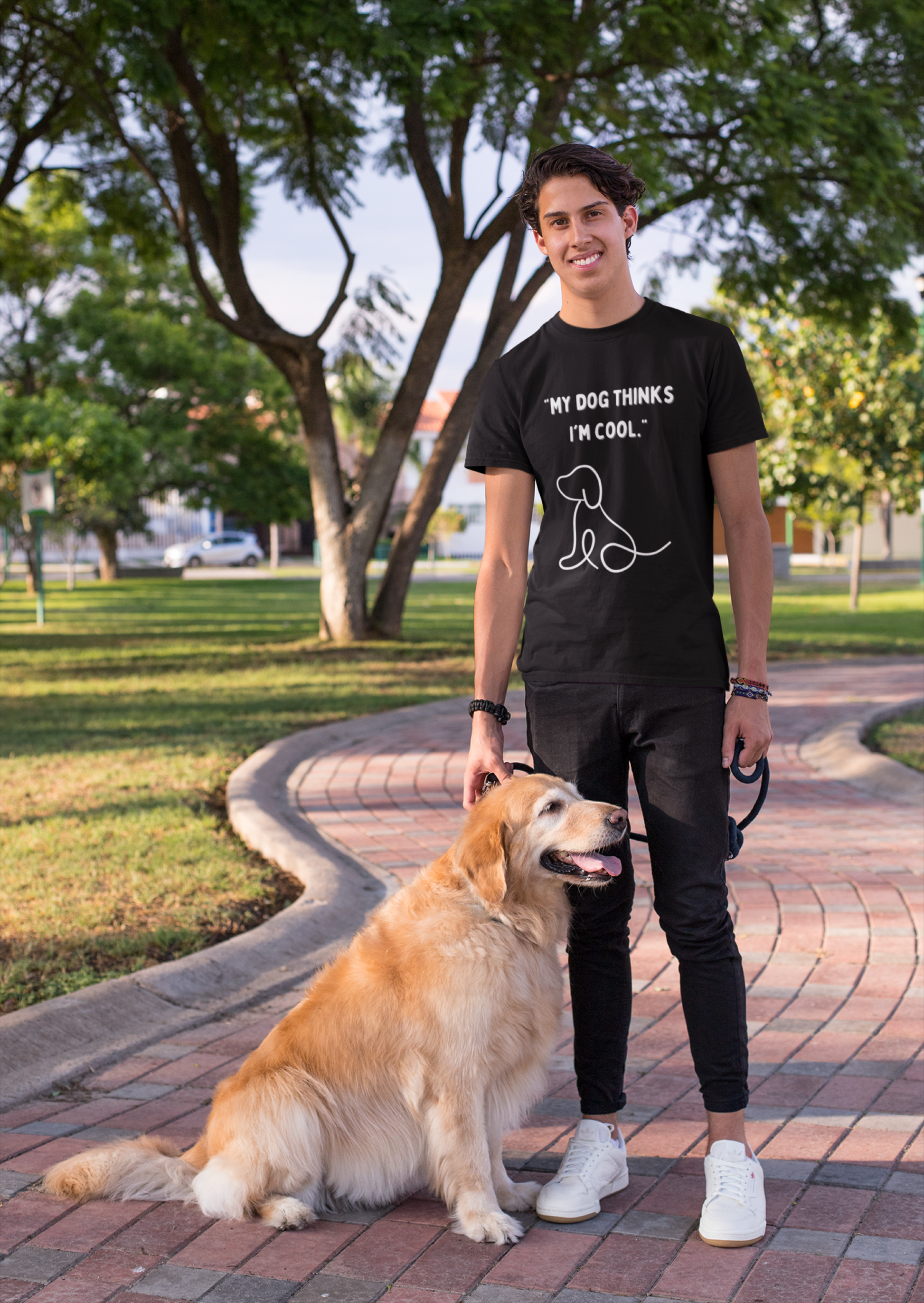 Young man wearing my dog thinks I am cool dog unisex shirt standing beside a golden retriever
