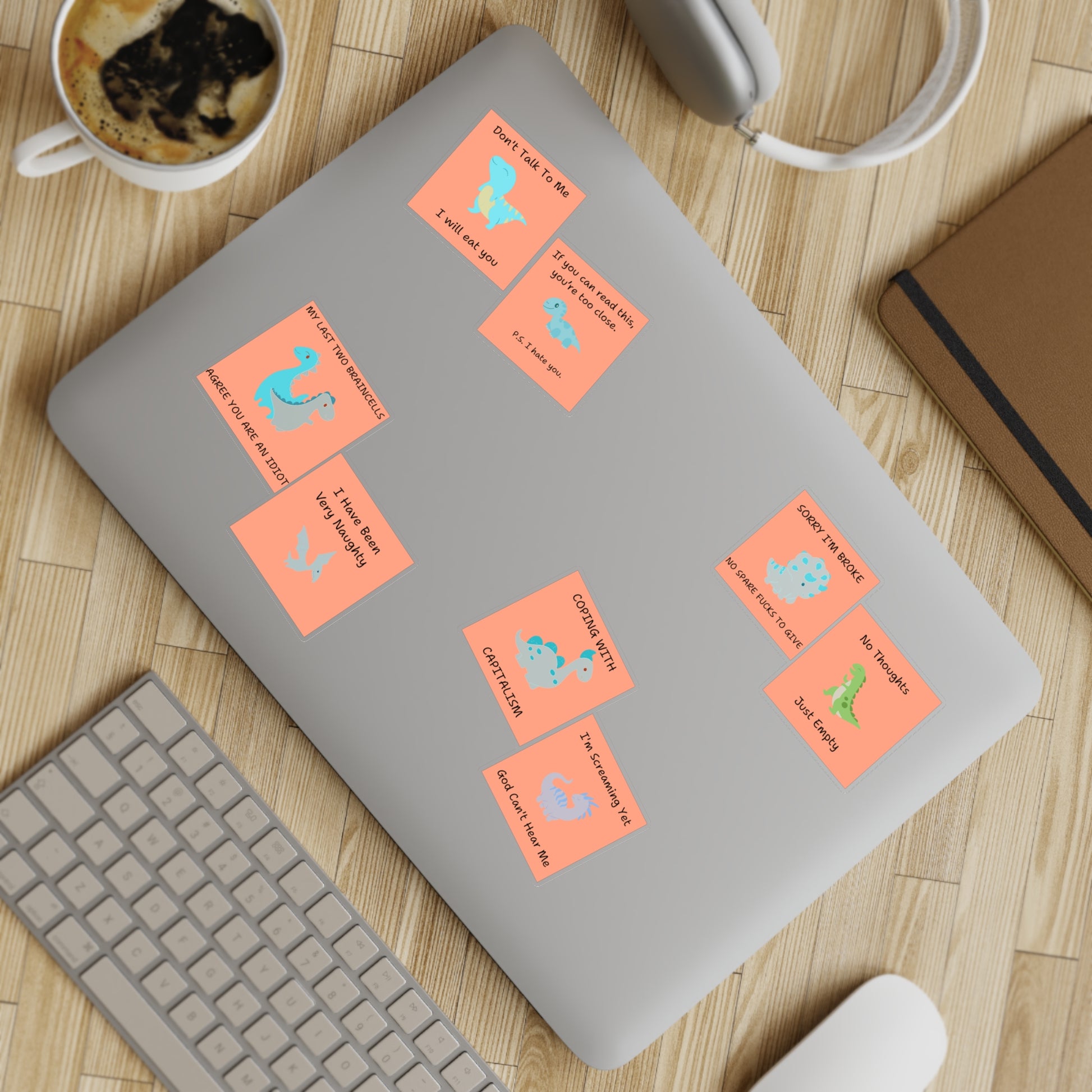 Funny edgy sarcastic cute dino sticker bundle on a laptop with a coffee cup