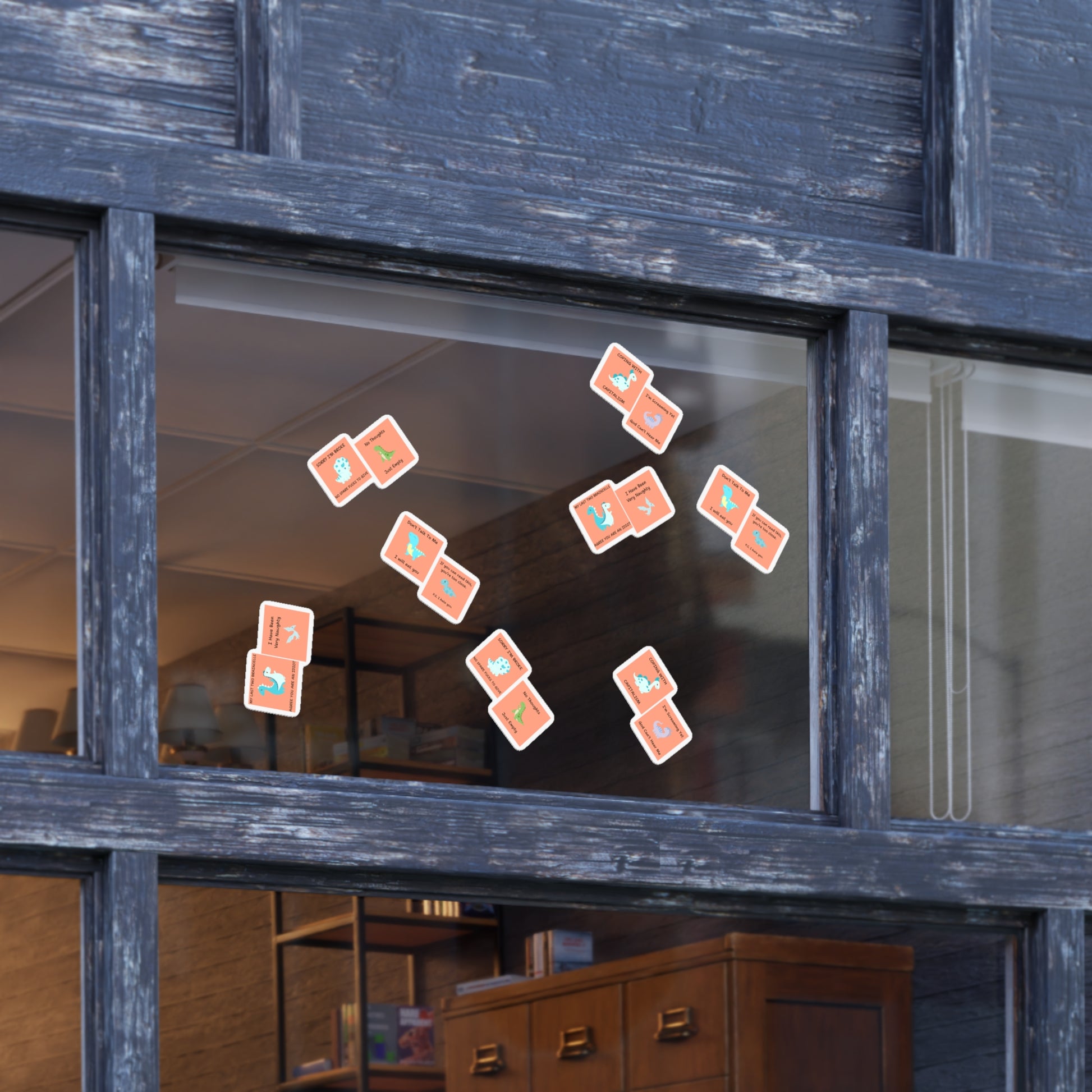 Window display featuring a funny edgy sarcastic cute dino sticker bundle in colorful designs