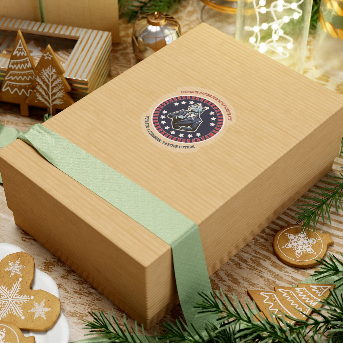 Gift box with funny political leopard face eating party sticker on top surrounded by holiday decorations