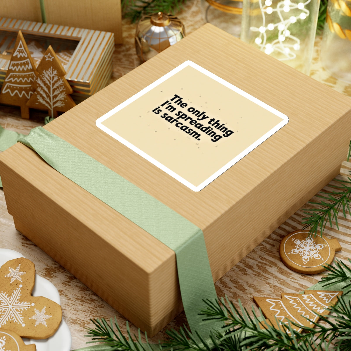 Brown gift box with green ribbon featuring a funny sarcasm stickers label in a festive holiday setting