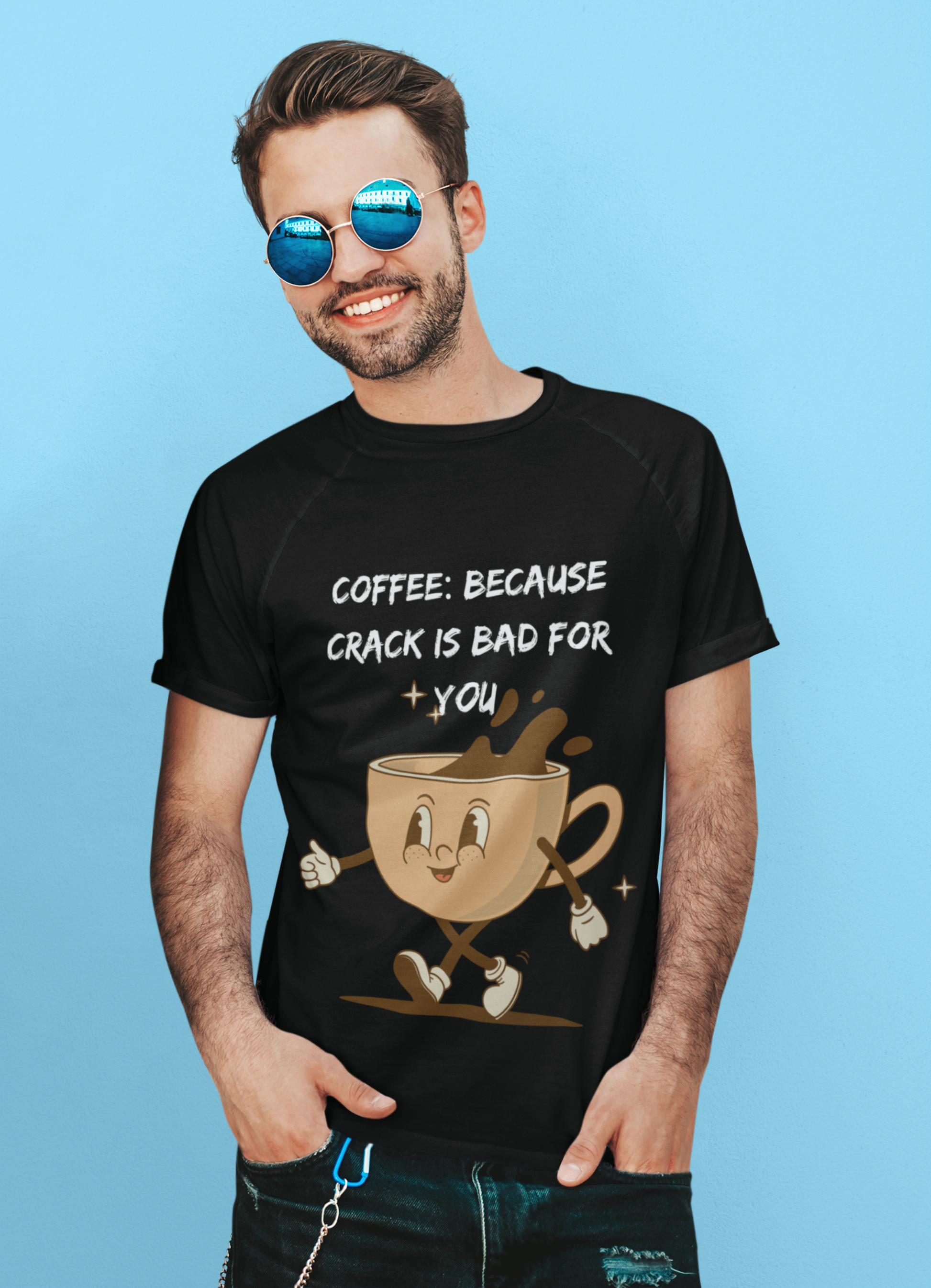Printify black T shirt with cartoon coffee design and slogan coffee because crack is bad for you shirt worn by smiling man