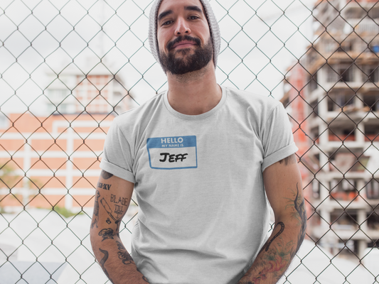Man wearing a gray my name is Jeff unisex funny shirt with name tag graphic sitting outdoors
