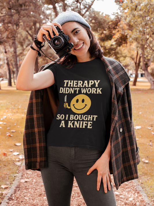 Woman outdoors wearing black tee with bold Therapy didnt work so I bought a knife print therapy dark joke humor unisex  t shirt .