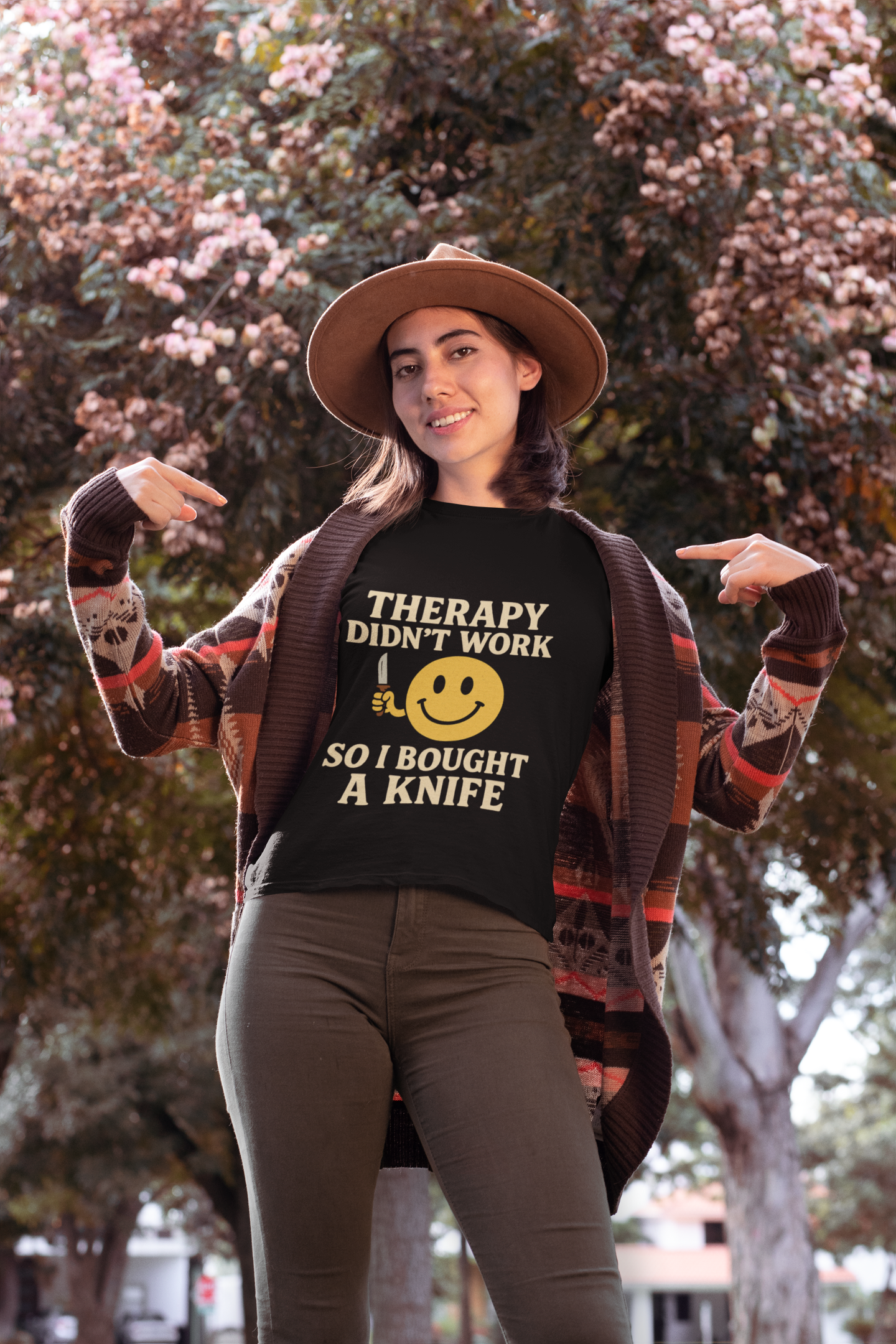 Model in Printify black tee with knife joke print and smiley face therapy dark joke humor unisex  t shirt .