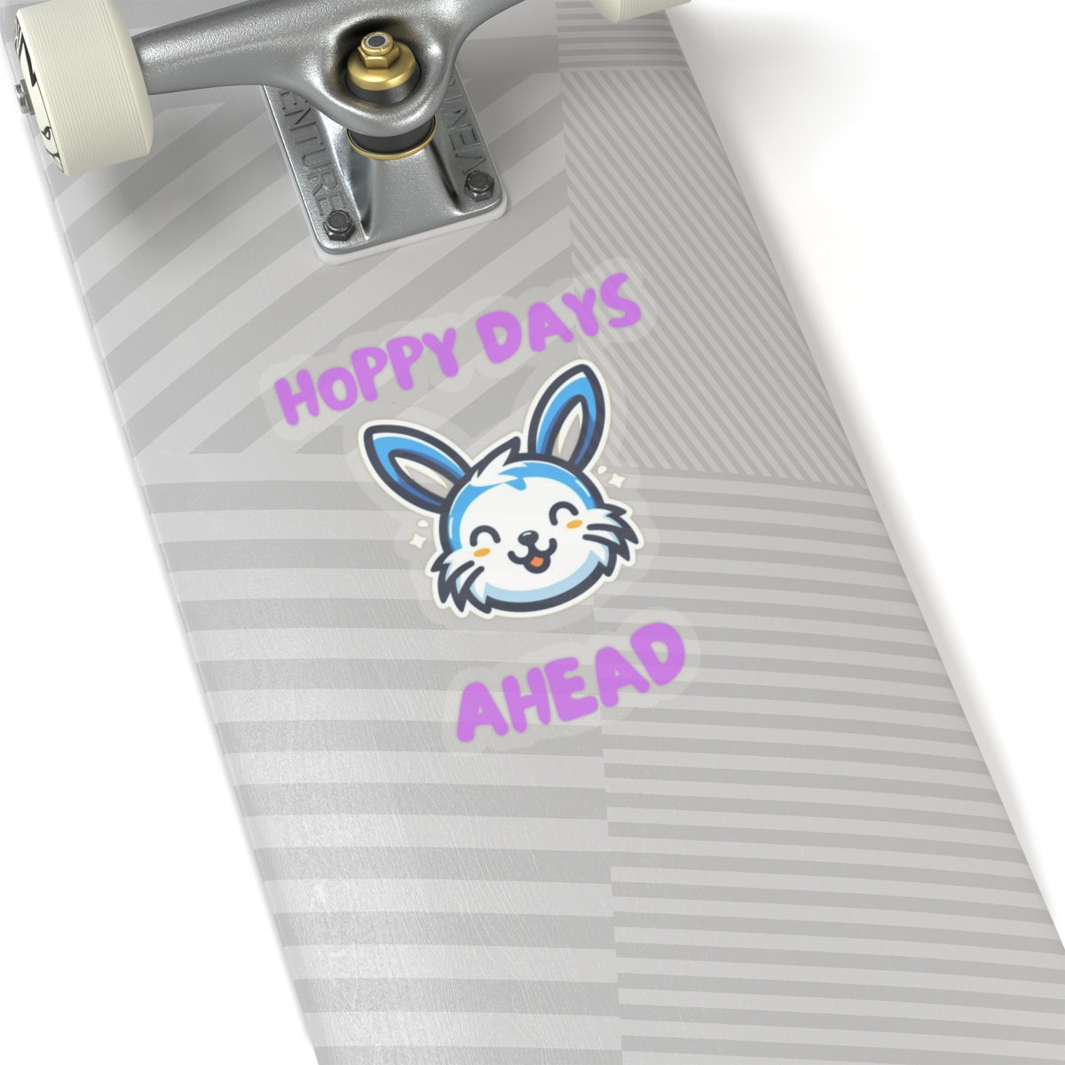 Hoppy days cute bunny sticker on gray striped skateboard deck with wheels and trucks