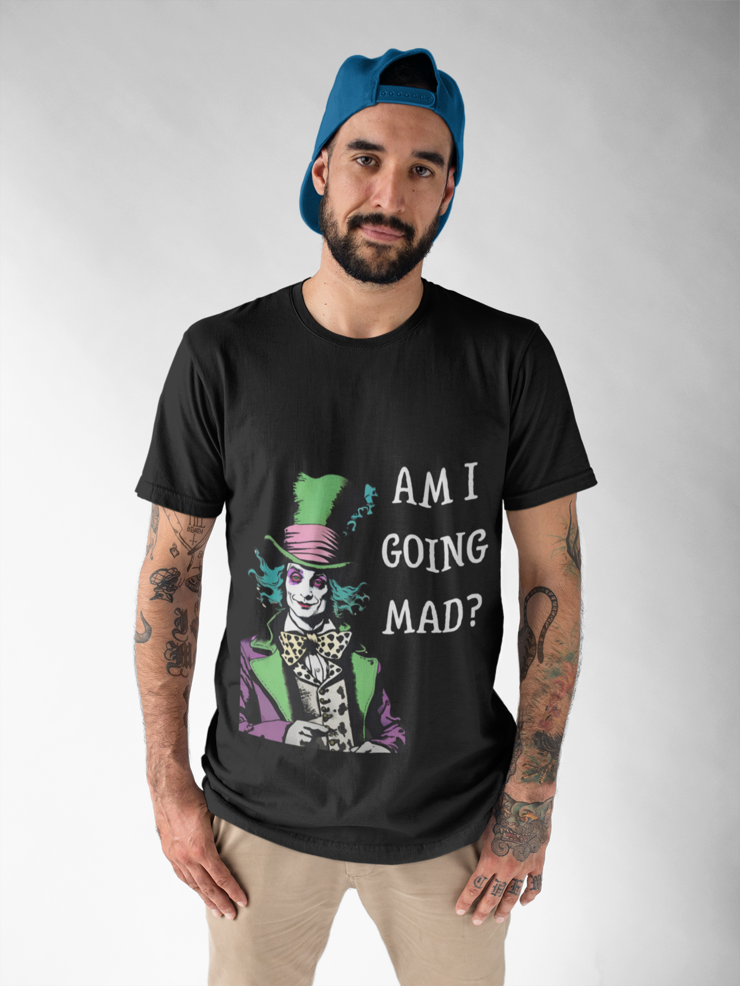 Black Printify t-shirt featuring mad hatter am i going mad vintage unisex shirt design worn by tattooed man