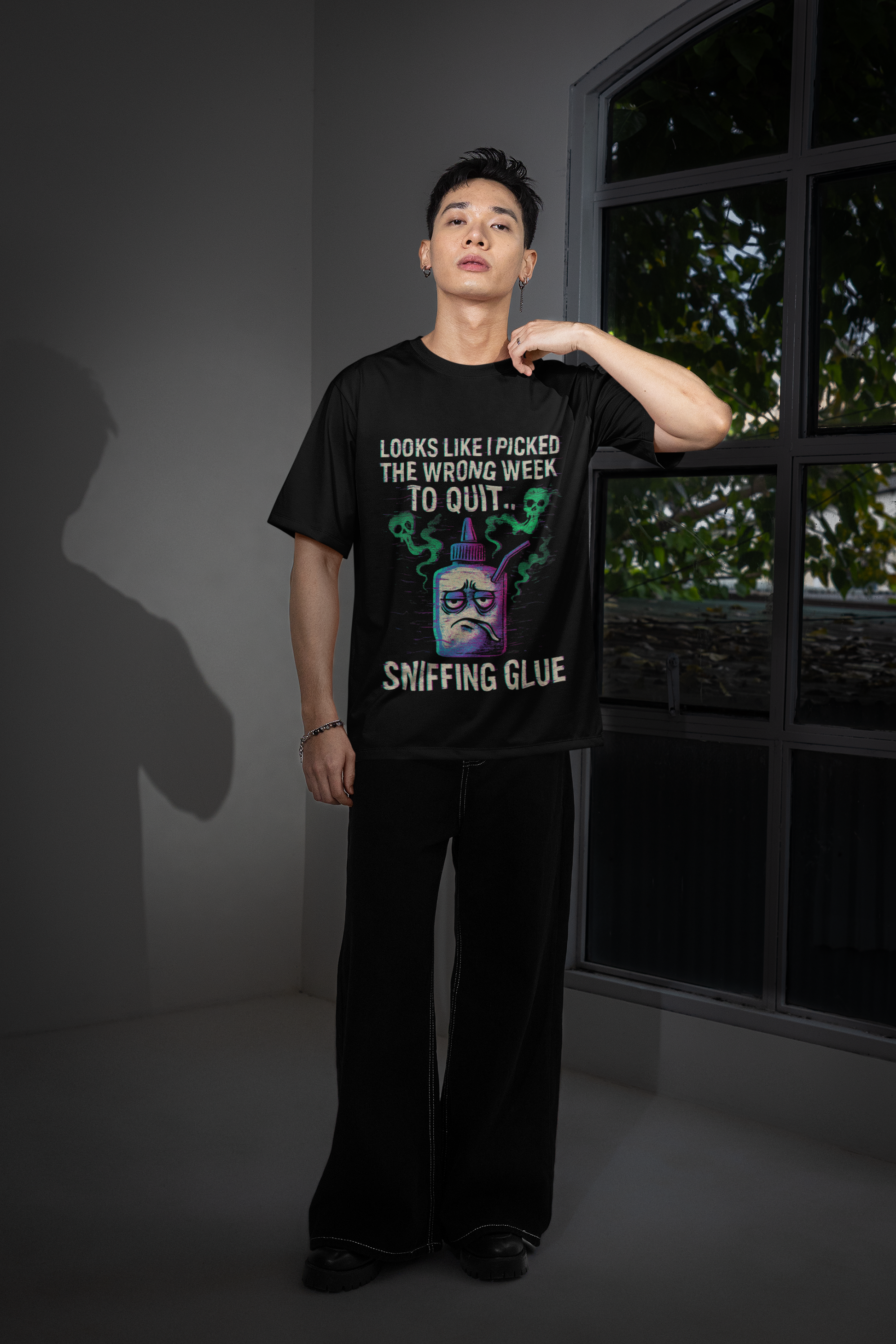 Male model wearing black unisex T shirt with colorful cartoon can and movie quote text sniffing glue movie quote meme unisex shirt