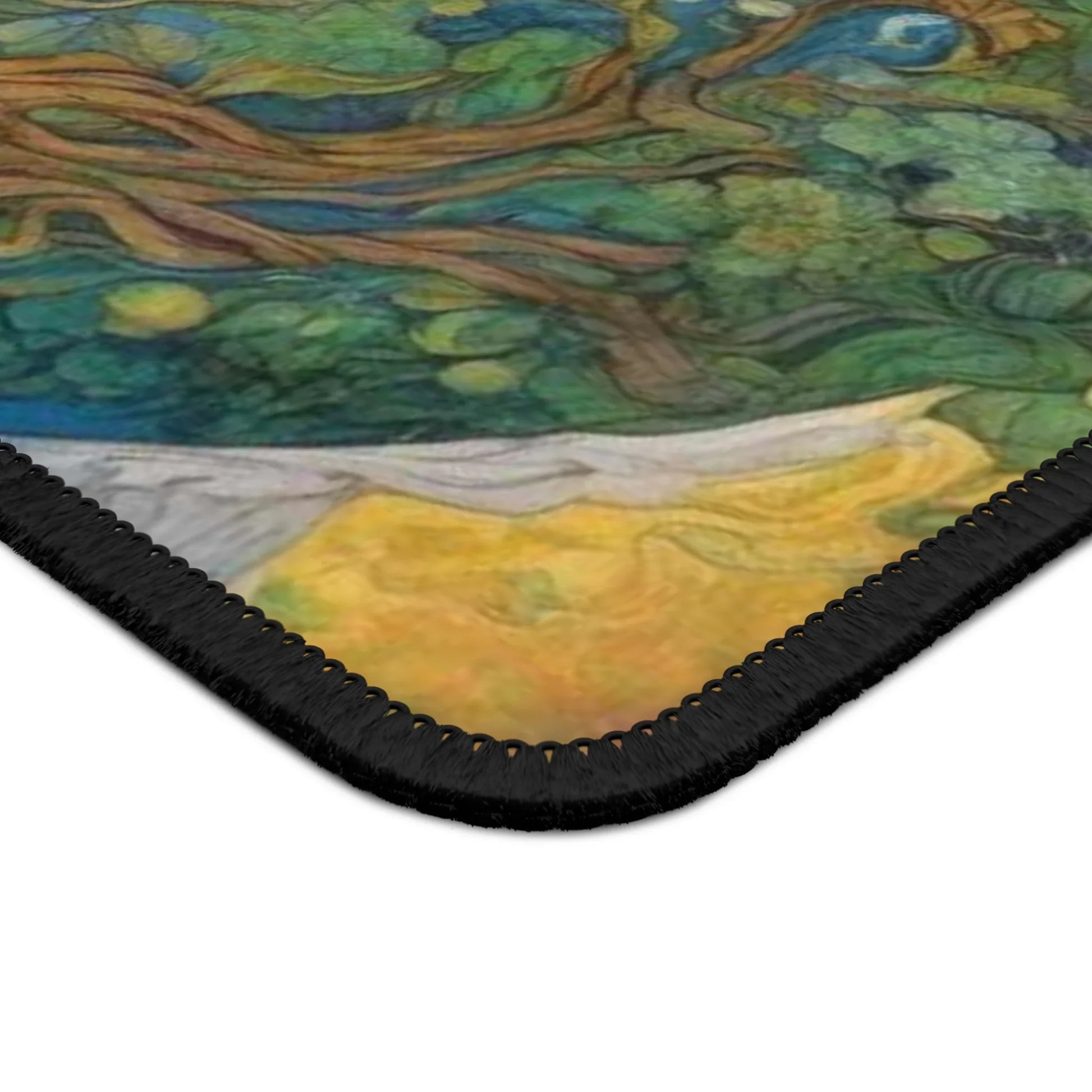 Close-up of a colorful Mother Nature gaming mouse pad with a stitched black edge for durability