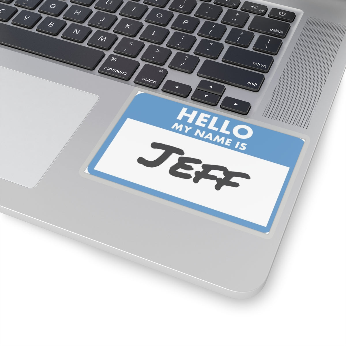 Blue and white my name is Jeff sticker on a silver laptop keyboard for name identification