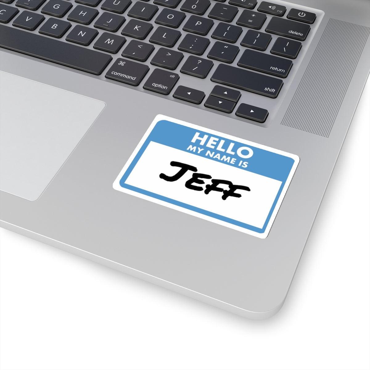 Printify my name is Jeff sticker placed on a silver laptop keyboard area with blue and white design