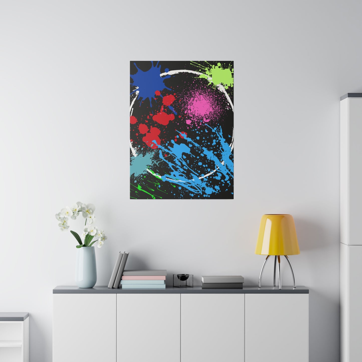 Neon eclipse abstract canvas wall art with colorful splatters hanging above white cabinet