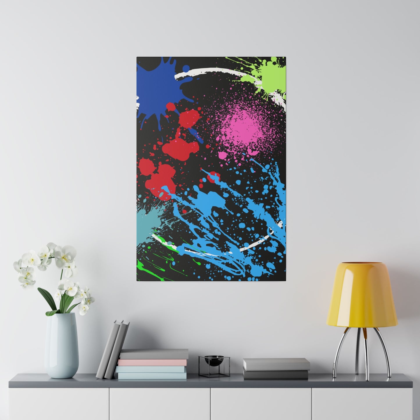 Neon eclipse abstract canvas wall art with colorful splashes displayed above a modern white cabinet
