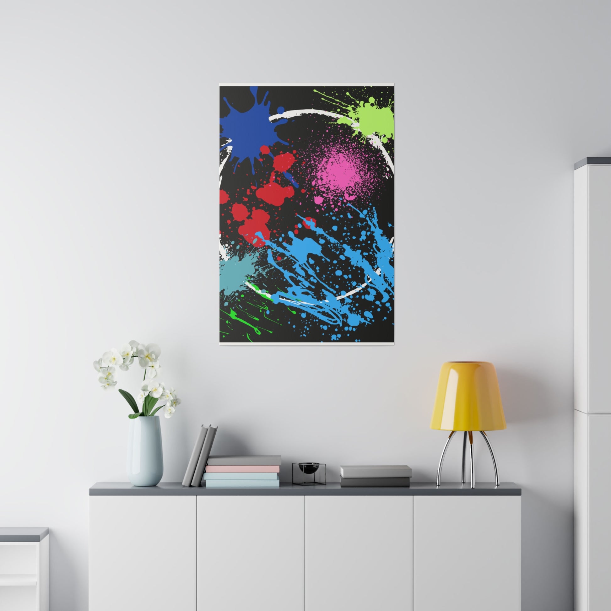 Neon eclipse abstract canvas wall art with colorful paint splatters hanging above white cabinet