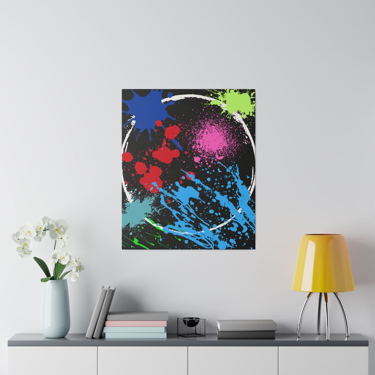 Neon eclipse abstract canvas wall art with colorful splatter design displayed above modern shelf