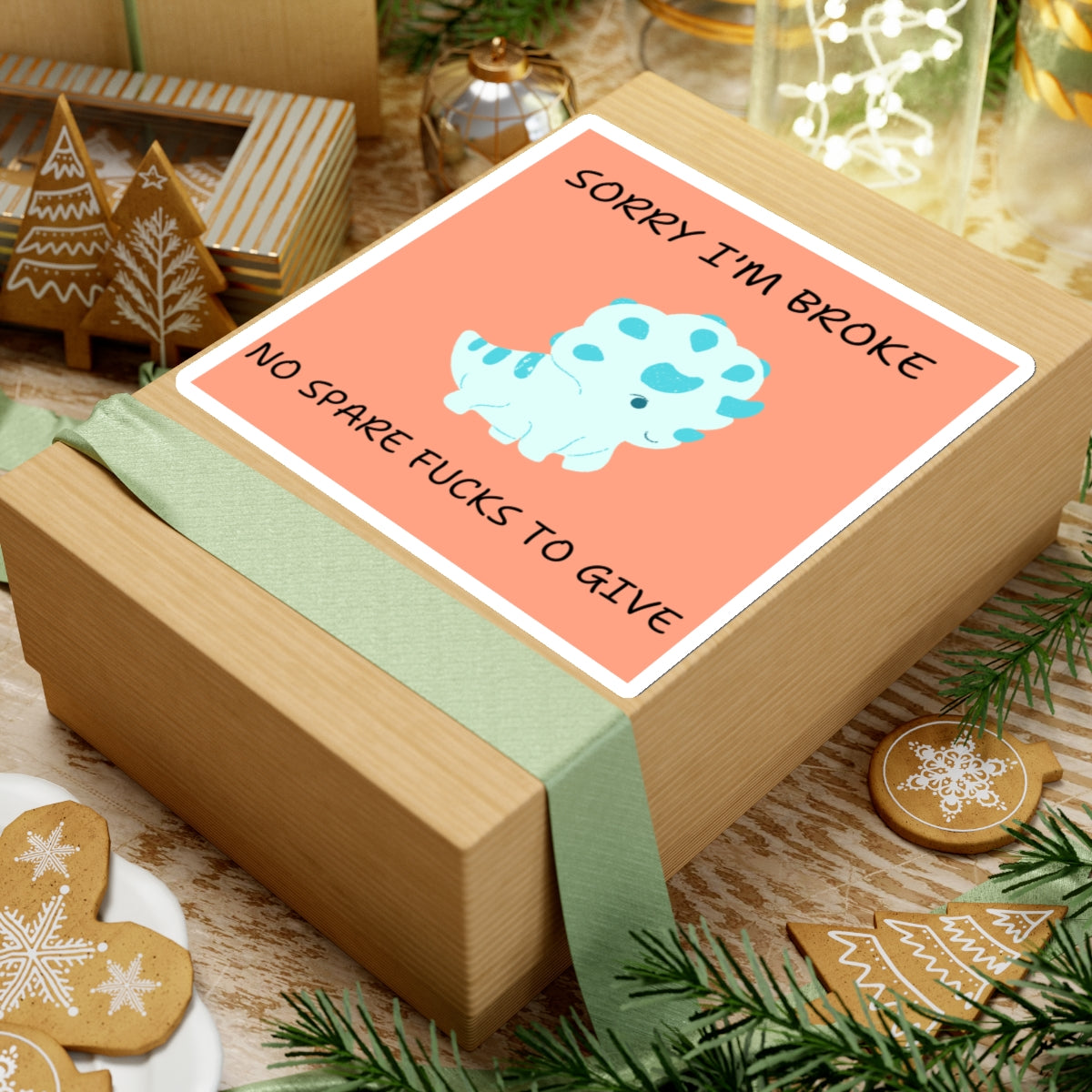No fucks to give funny dino sticker on a gift box with holiday decorations and gingerbread cookies
