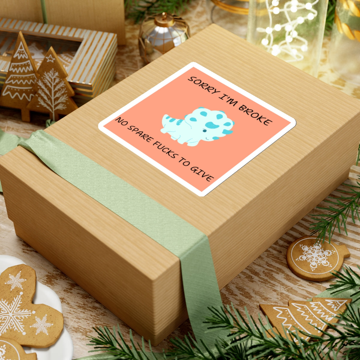 No fucks to give funny dino sticker on a gift box with holiday cookies and decorations