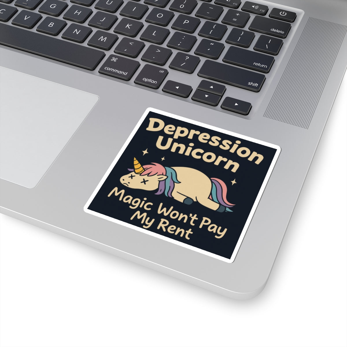 Funny cute unicorn art sticker on laptop showing pastel sad sleeping unicorn and text Depression Unicorn Magic Wont Pay My Rent