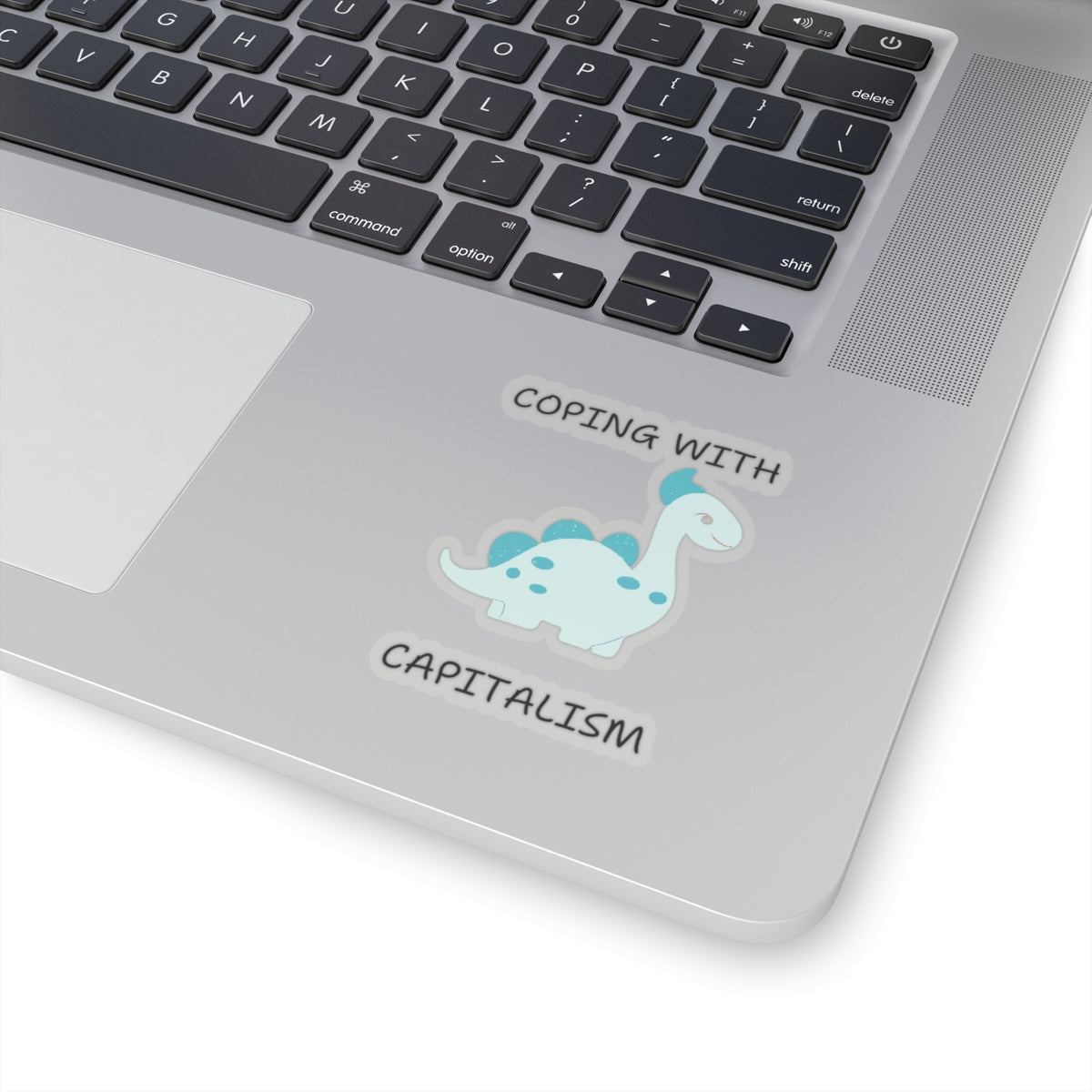 Unique sarcastic cute dinosaur sticker on silver laptop with coping with capitalism text