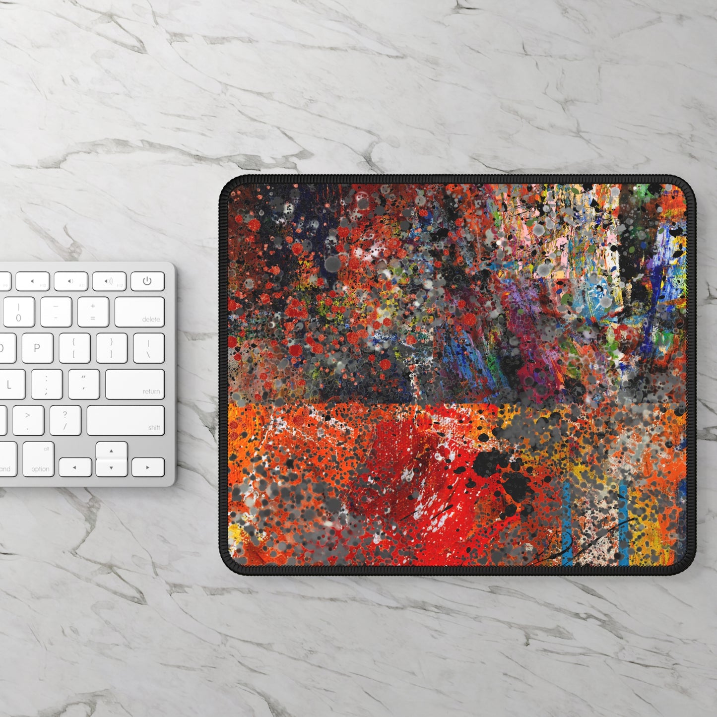 Printify red and orange abstract splatter art mousepad on marble desk showing vibrant paint texture