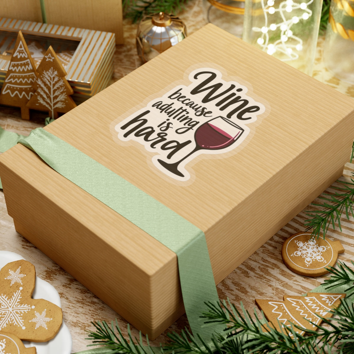 Wine because adulting is hard funny sticker on a gift box with holiday decorations and cookies