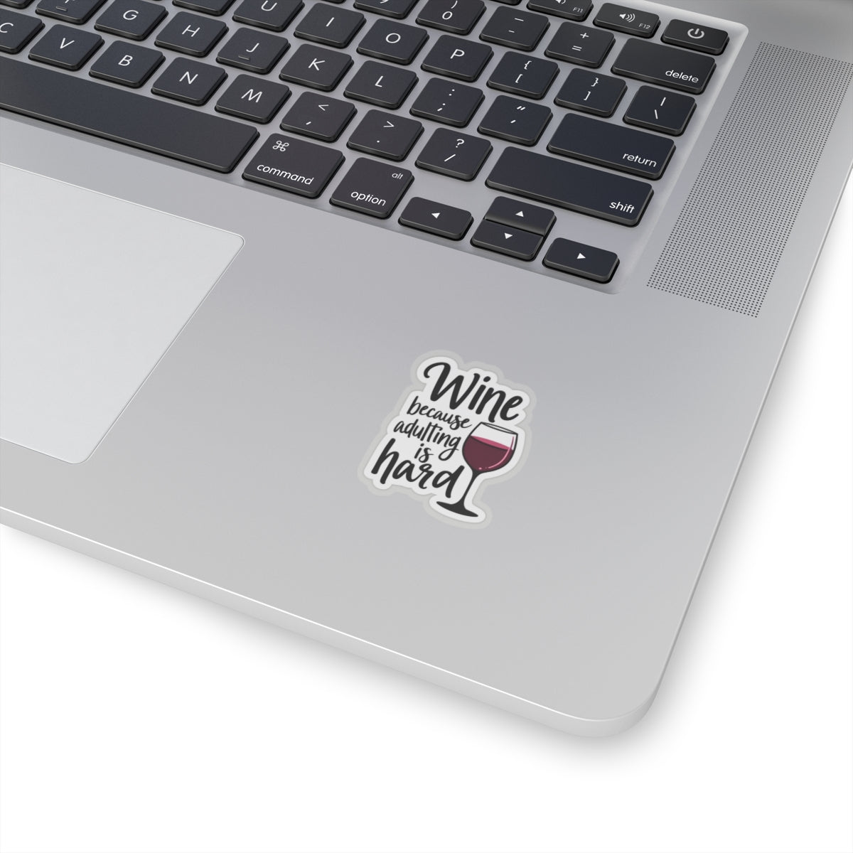 Wine because adulting is hard funny sticker on silver laptop showing black text and wine glass illustration