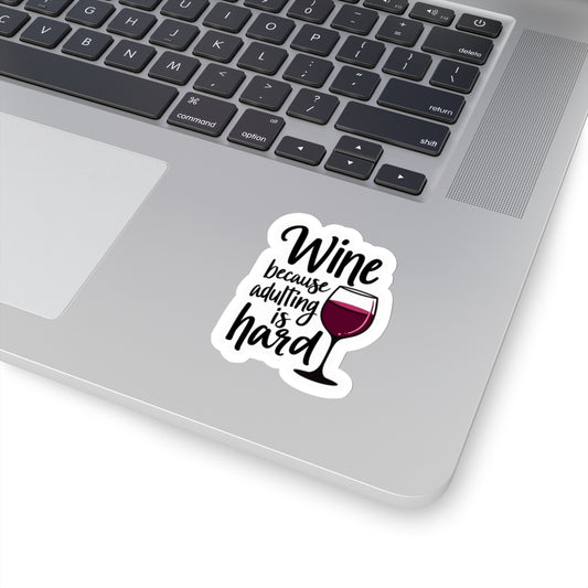 Wine because adulting is hard funny sticker with wine glass on laptop surface by Printify